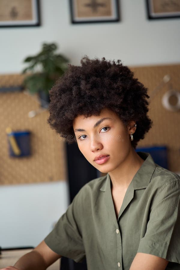files/young-pretty-african-girl-student-sitting-home-office-vertical-portrait-confident-years-american-woman-looking-camera-398325474.jpg